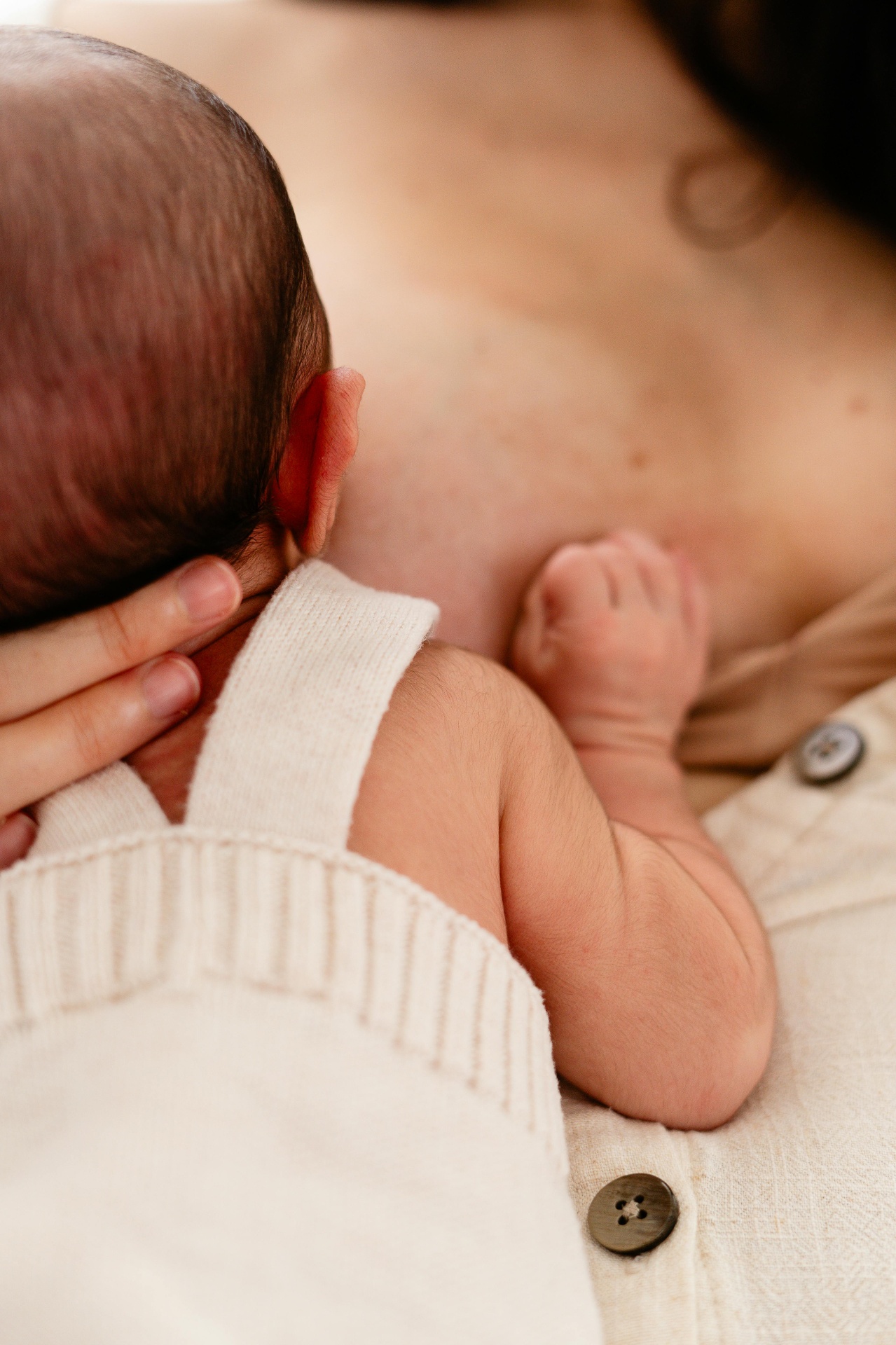 Newborn baby resting on mother's chest in soft natural light — bone broth and breastfeeding