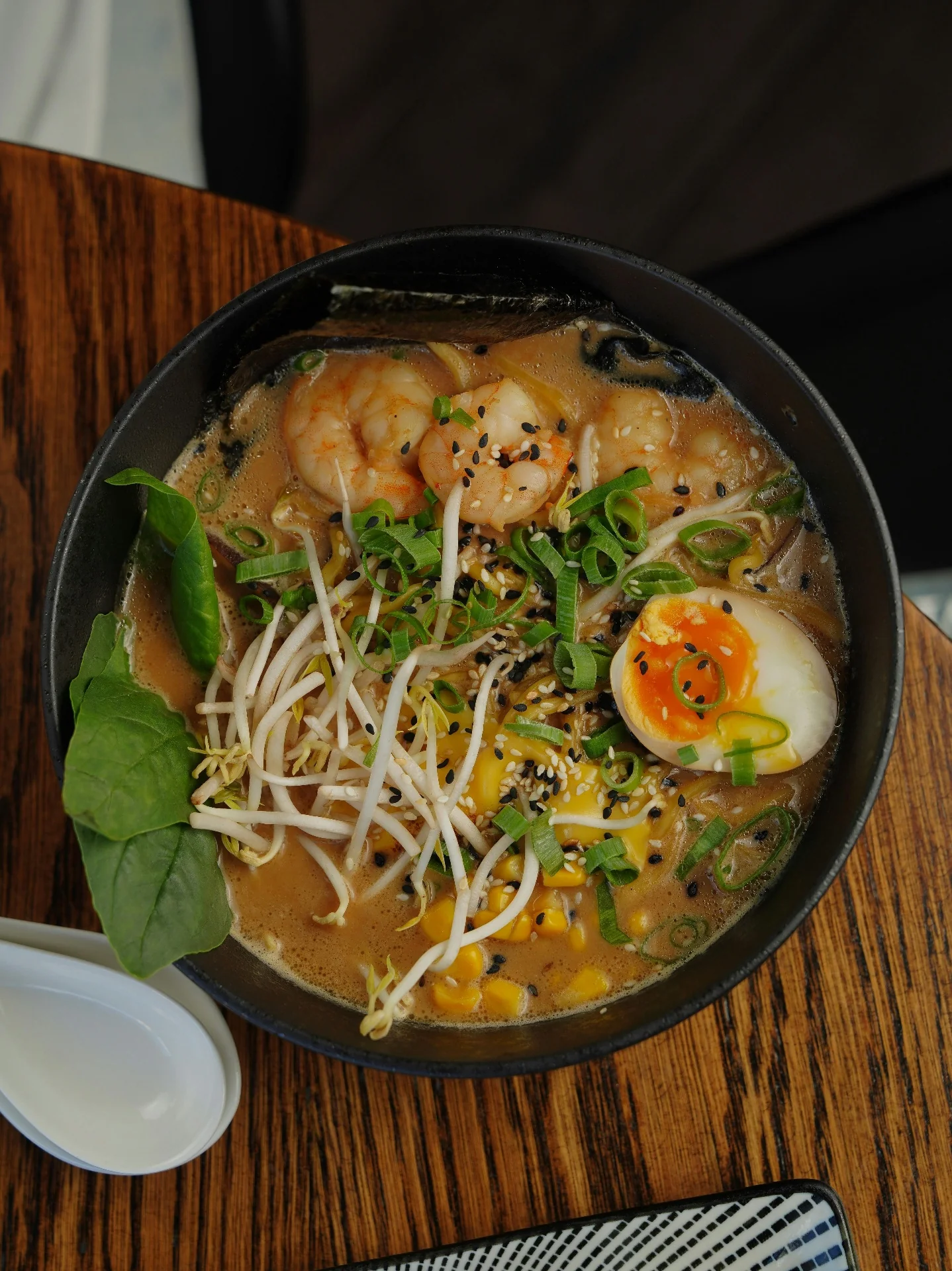 Golden bone broth ramen with shrimp, soft-boiled egg and bean sprouts